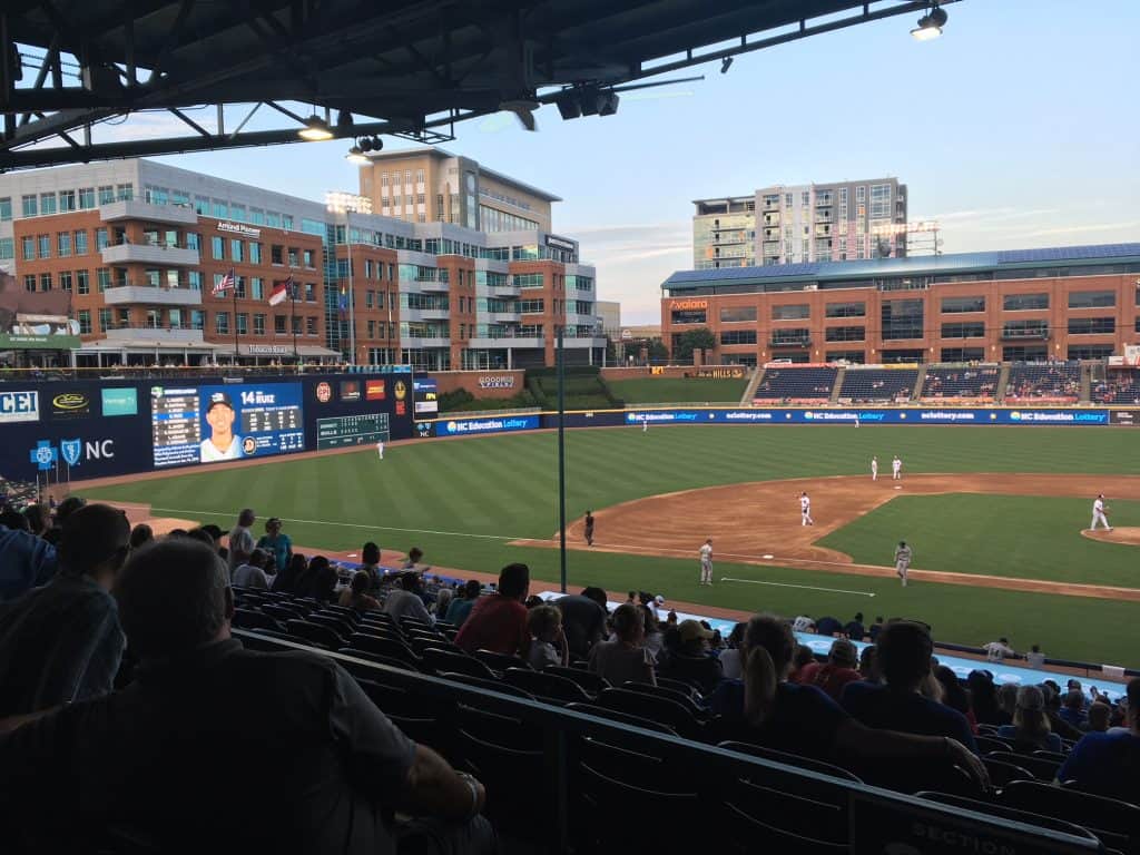 A baseball game going on in the park