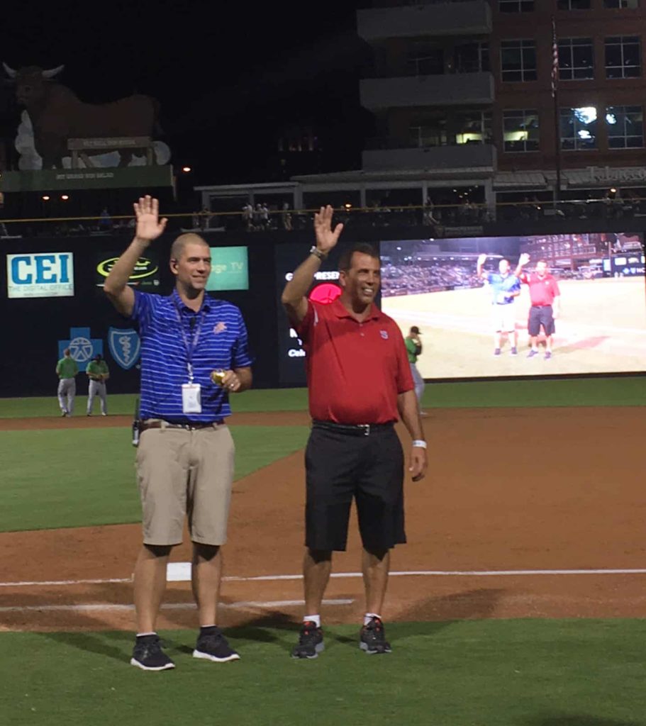 Clean Transportation Director Rick Sapienza accepting the game ball on the field