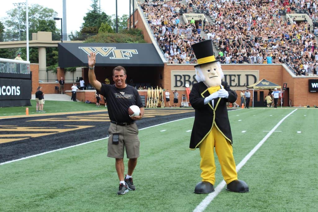 Clean Transportation Director Rick Sapienza accepting game ball from Wake Forest’s mascot